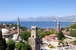 close up shot of a clock tower and minaret in Antalya