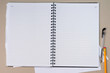 Open blank notebook on a grey background