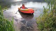 boy rowing on an inflatable boat away from coast