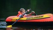 boy turn round on an inflatable boat on water