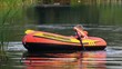 boy turn round on an inflatable boat on lake