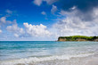 Stone cape in ocean with blue sky