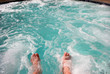 Dipping toes in warm bubbly hot tub