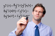 Teacher writing a maths equation.