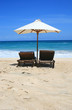 two chairs and umbrella on the see