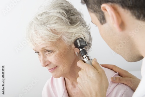 Photo: Mid adult doctor examining senior patient Mid adult doctor examining senior patient