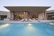 Swimming pool and paved seating area of Palm Springs home exterior