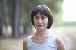 Mid adult woman stares directly at camera, portrait