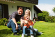Family sitting in front of their home
