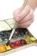 man's hand with paintbrush on it