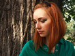 Dreaming redheaded girl with interesting makeup