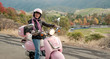 sixty year old biker cruising down a hillside