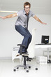 Photo: Man skateboarding on a chair Man skateboarding on a chair