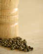 Wooden shaker and a green pepper close up
