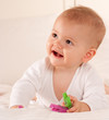 Smiling baby with pegs