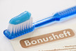 Foto: toothbrush with blue toothpaste and german bonusheft booklet toothbrush with blue toothpaste and german bonusheft booklet