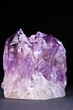 Crystals of magenta amethyst shined on a dark background