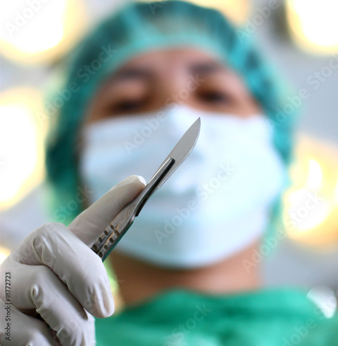 Photo: close up of surgeon with a surgical knife close up of surgeon with a surgical knife
