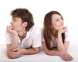 Happy girl and man on bed. Young family. Isolated.
