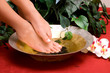 Woman's feet in bowl of water