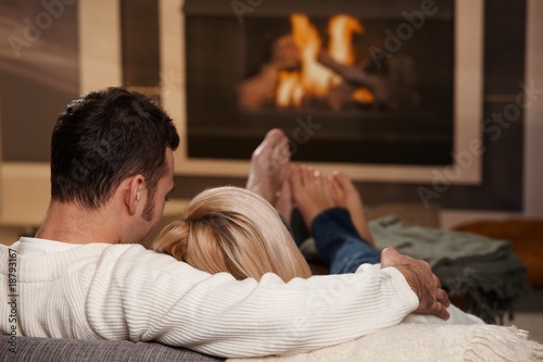 Photo: Couple sitting at fireplace Couple sitting at fireplace