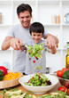 Photo: Little boy and his father cooking Little boy and his father cooking