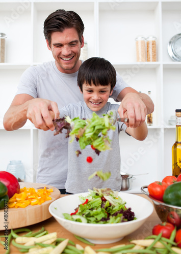 Photo: Little boy and his father cooking Little boy and his father cooking