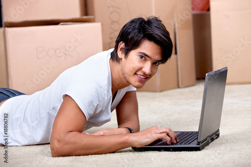 Photo: Man using a computer while moving Man using a computer while moving