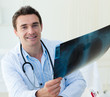 Attractive doctor examining an x-ray Attractive doctor examining an x-ray