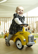 Smiling Baby Riding Toy Car