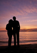 Newlyweds watching sunset on the seashore Newlyweds watching sunset on the seashore