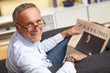 mature man reading newspaper
