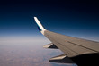 View of a plane wing in a blue sky