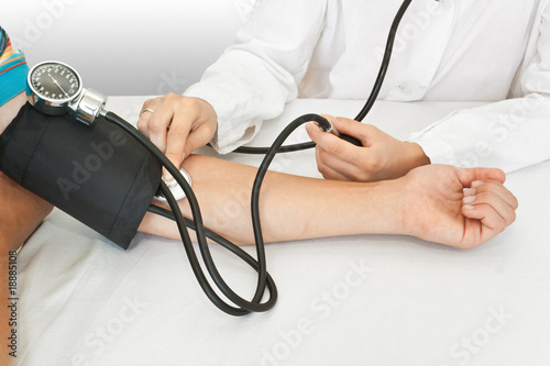 Photo: medicine concept. doctor measures pressure in the patient medicine concept. doctor measures pressure in the patient