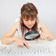 Girl with poor eyesight works with computer keyboard Girl with poor eyesight works with computer keyboard