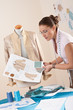 Female tailor working at fashion designer studio