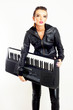 punk rock fashion girl holding a piano keyboard punk rock fashion girl holding a piano keyboard