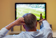 Mature man watching football on TV