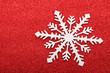 Single snowflake on red background