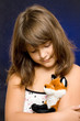 Portrait of a sad girl with pet toy
