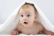 Infant below towel