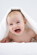 Crying baby under towel.