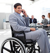 Businessman in a wheelchair on phone during a meeting