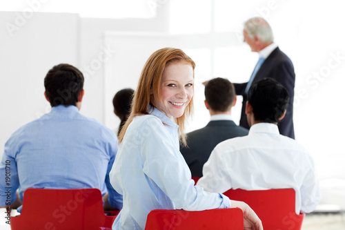Foto: Smiling caucasian businesswoman at a conference Smiling caucasian businesswoman at a conference