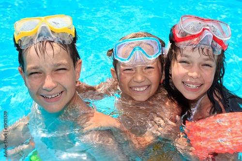 Photo: Three happy children in pool Three happy children in pool