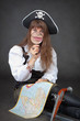 Woman - captain of sea pirates with map and magnifier in hands Woman - captain of sea pirates with map and magnifier in hands