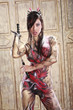 Asian girl in bodypainting with nunchuks