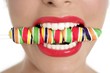 Colorful Lollypop in perfect woman teeth Colorful Lollypop in perfect woman teeth