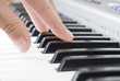 hand playing music on the piano