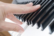 hand playing music on the piano
